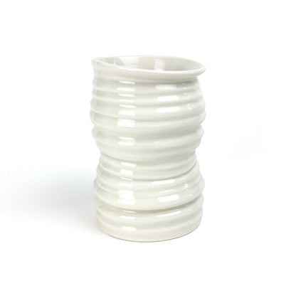A cylindrical ceramic Yunomi tea cup with evenly spaced horizontal ridges and a slightly flared rim.