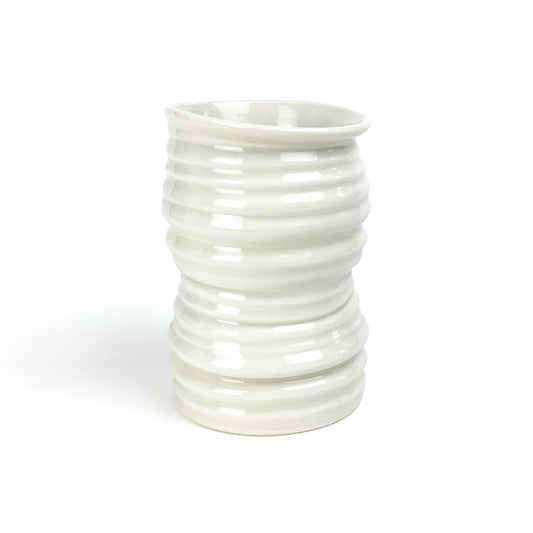 A cylindrical ceramic Yunomi tea cup with evenly spaced horizontal ridges and a slightly flared rim.