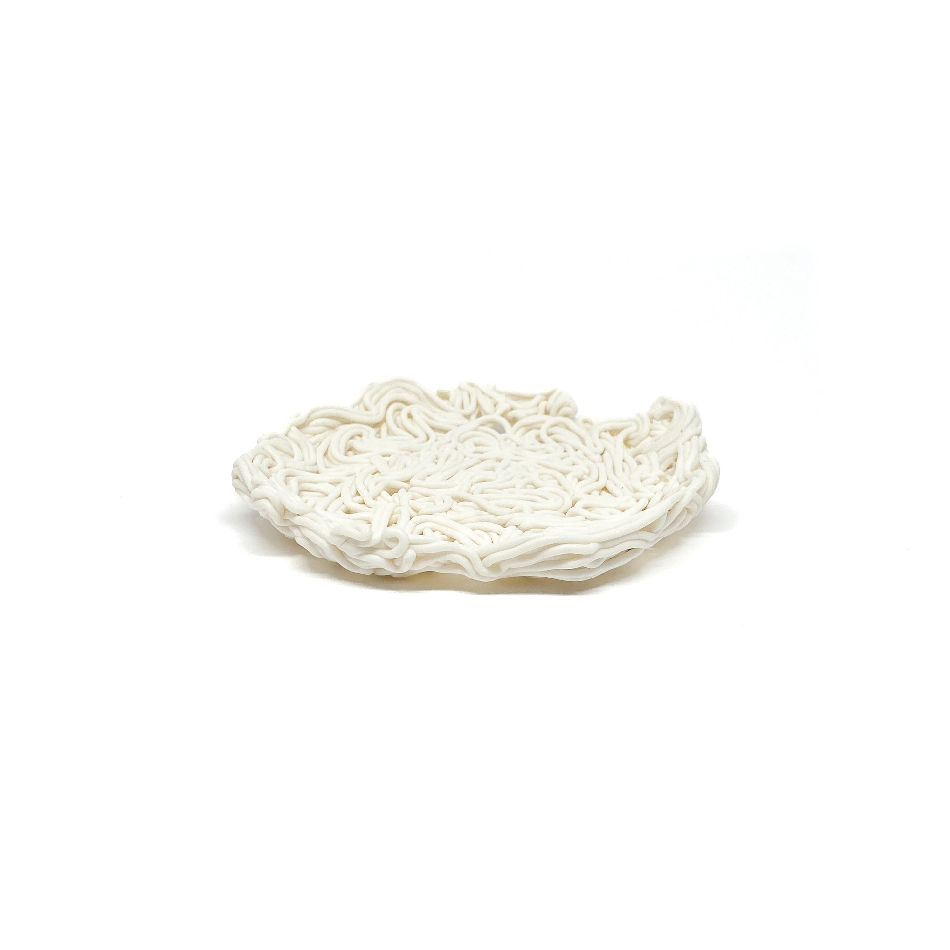 A shallow, round ceramic spiral tealight holder with a dense, noodle-like texture.
