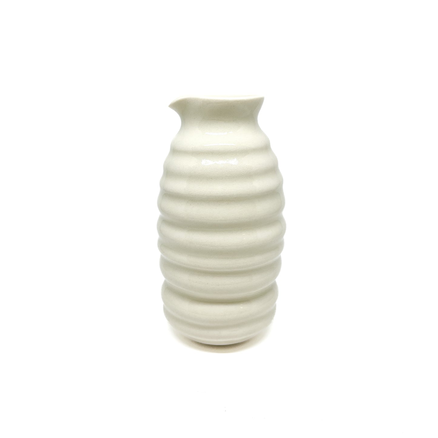 A ceramic vase with a beehive shape, featuring stacked horizontal ridges and a slightly flared, asymmetrical top.