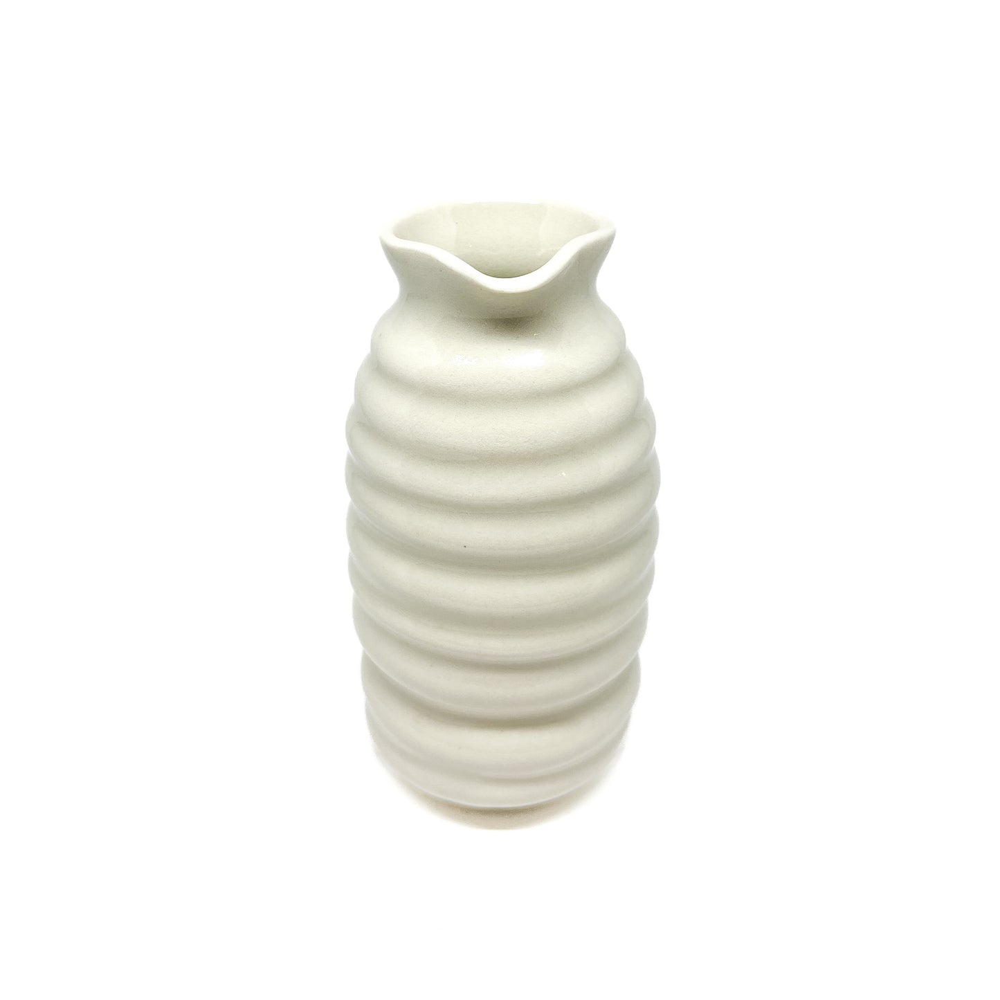 A ceramic vase with a beehive-like form, featuring stacked horizontal ridges and a wavy, flared opening at the top.