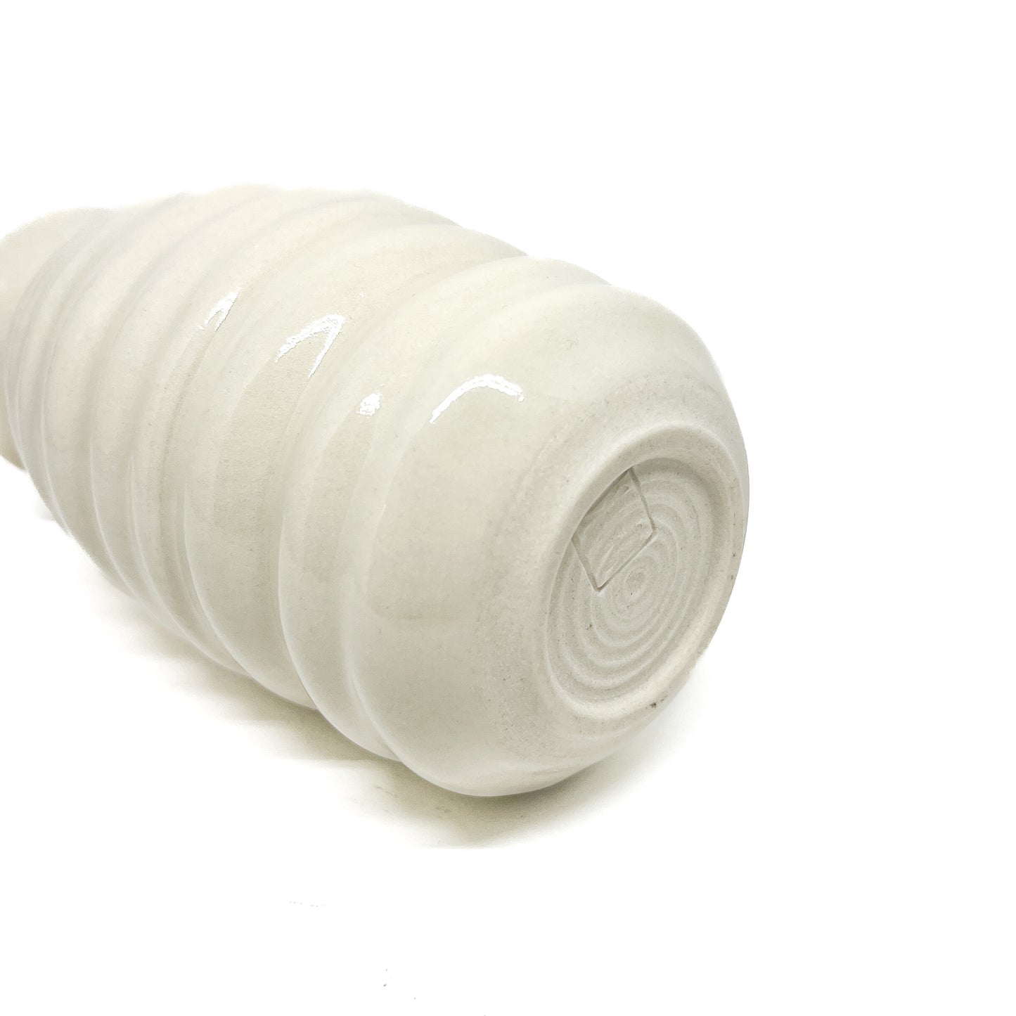 Bottom view of a ceramic Haeger Beehive Swirl Vase, showing concentric circular markings and a small, rectangular maker's mark. The vase has horizontal ridges.