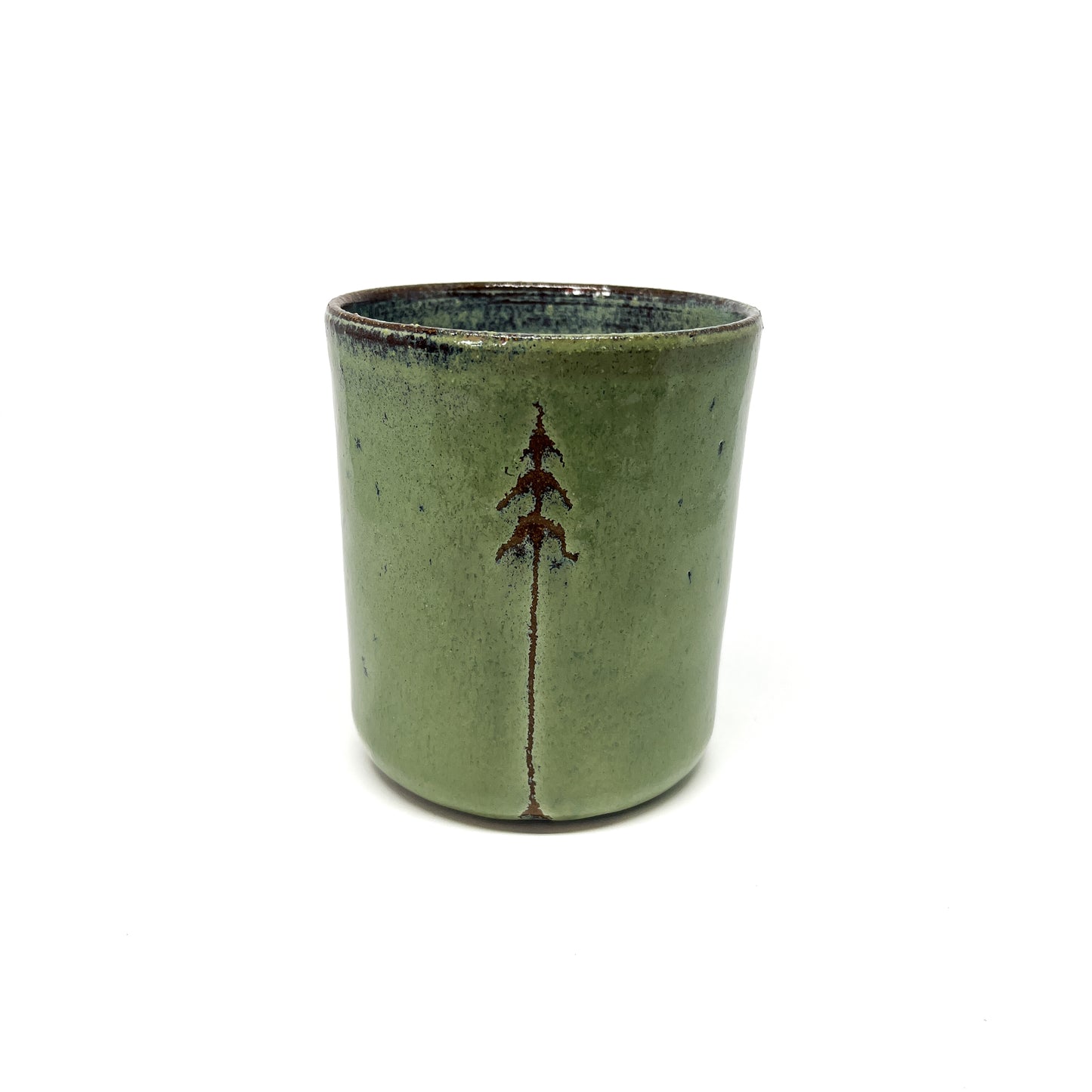 Green ceramic cup with a tree design, centered on a white background.