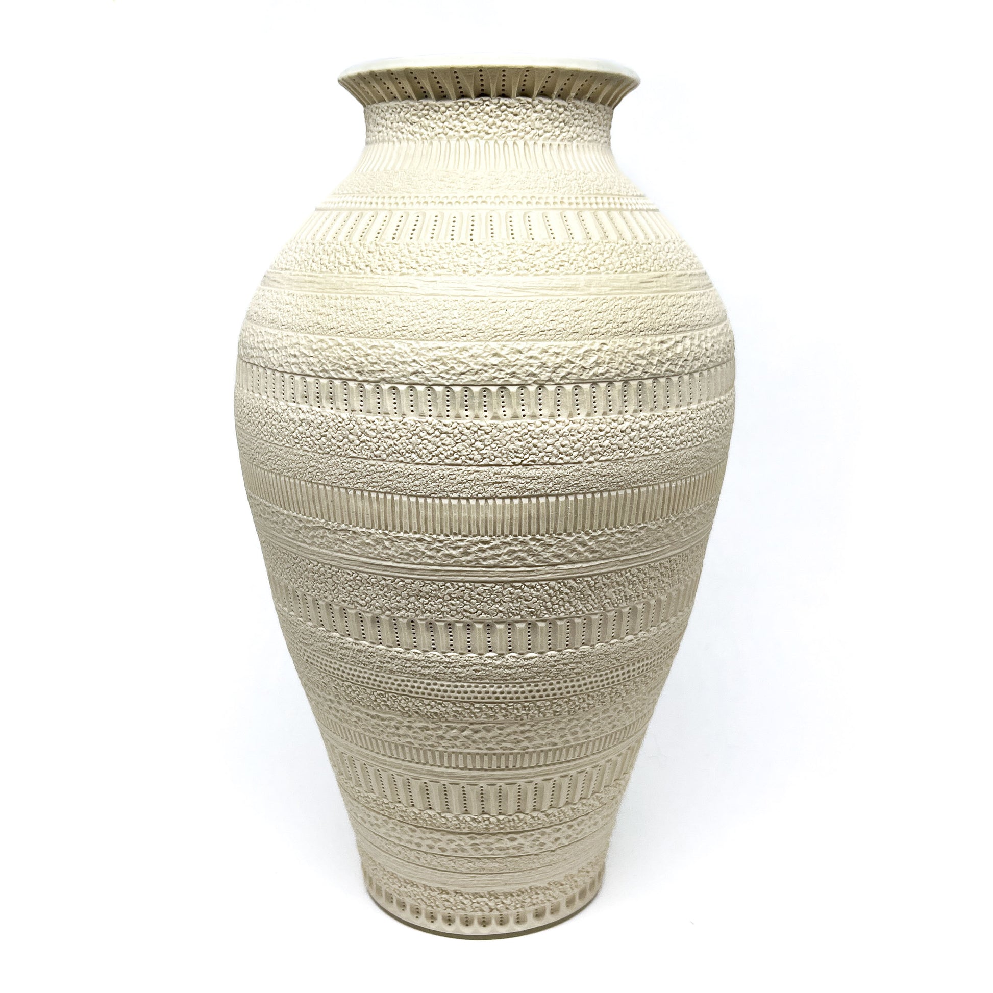 A large, off-white ceramic vase with intricate, textured horizontal bands and a narrow neck.