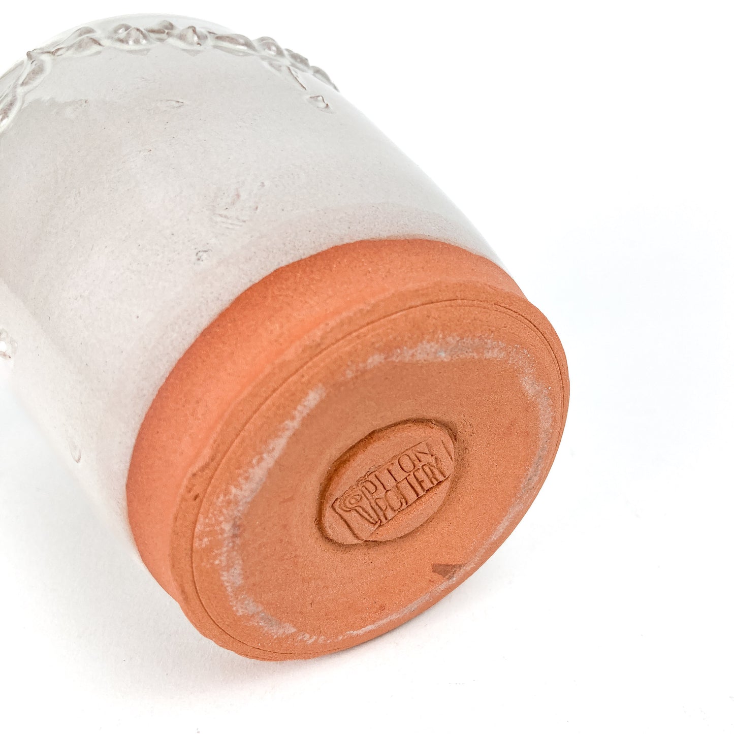 Bottom view of a ceramic tumbler revealing its unglazed base and the "Cotton Pottery" maker's mark.