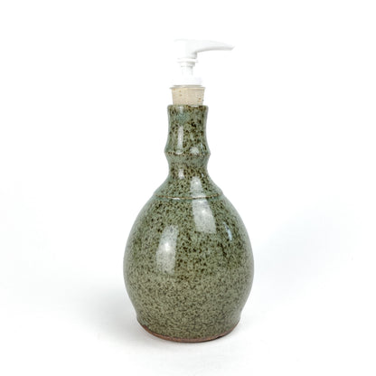 Coral Patola Celadon Pump Bottle, a textured ceramic dispenser with a white pump and unglazed base.