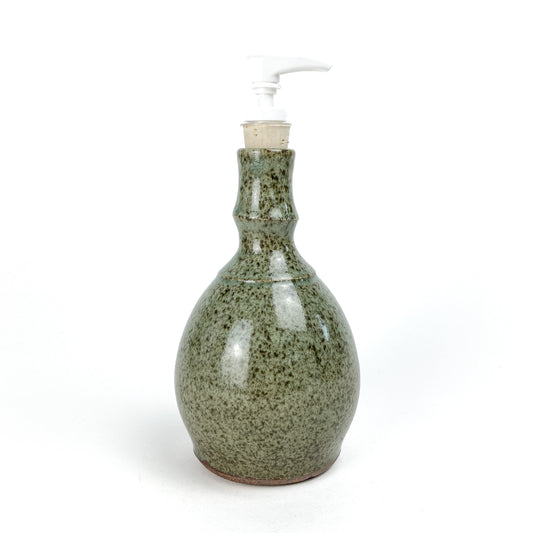 Coral Patola Celadon Pump Bottle, a textured ceramic dispenser with a white pump and unglazed base.