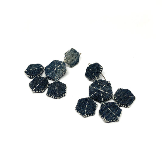 A pair of "Patched Chandelier" earrings featuring layered, stitched denim hexagons.