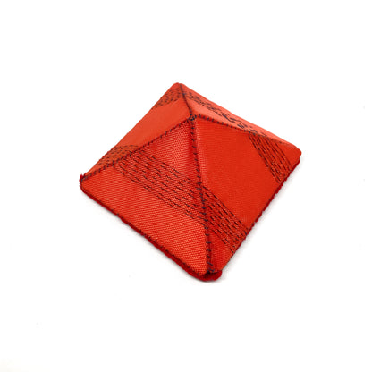 A square "Flagged Elevensies" brooch with a different fabric texture and darker stitched accents.