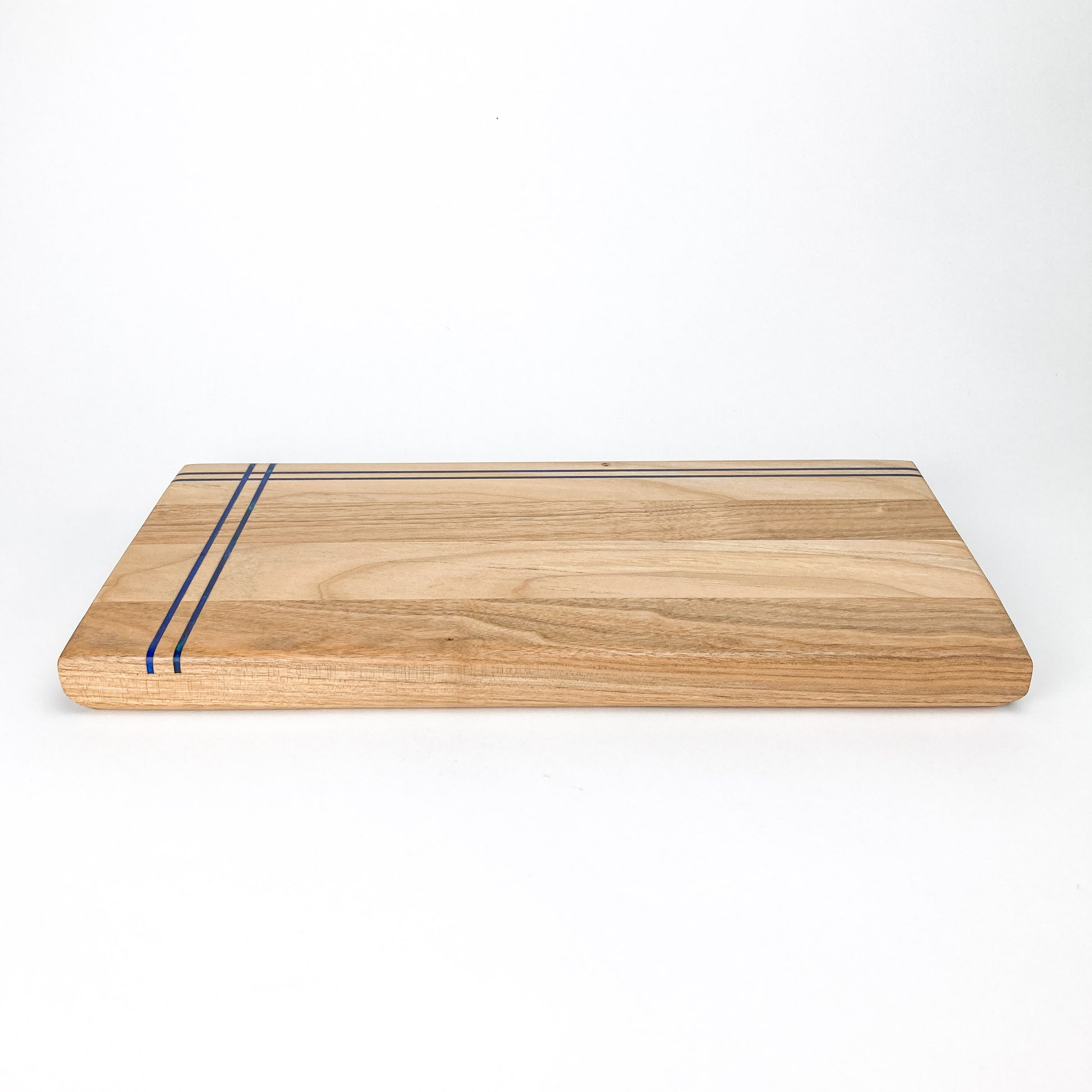 Side profile of the Butternut Railroad Charcuterie Board highlighting smooth edges and resin line continuity.
