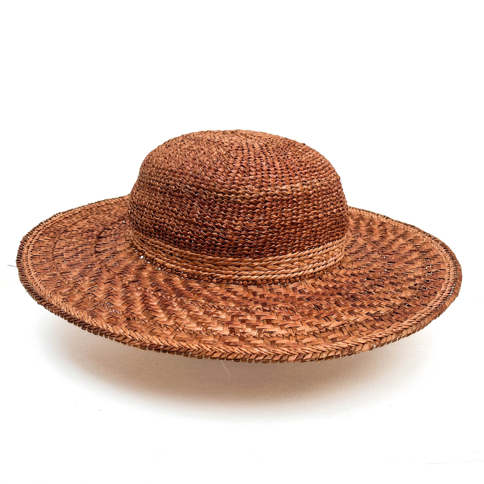 A wide-brimmed woven hat with a rounded crown, featuring a band around the base.
