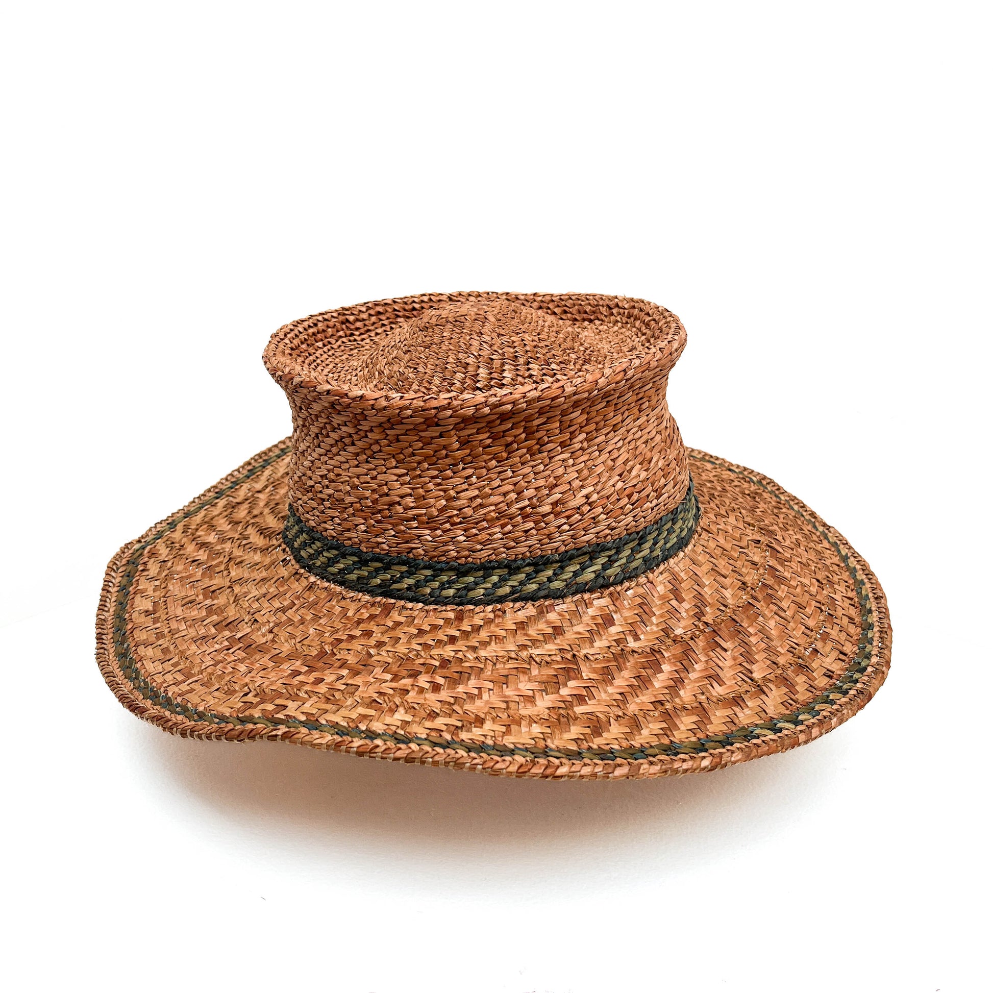 A woven hat with a cylindrical crown, wide brim, and a green band around the base.