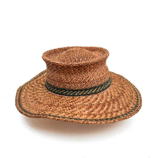 A woven hat with a cylindrical crown, wide brim, and a green band around the base.