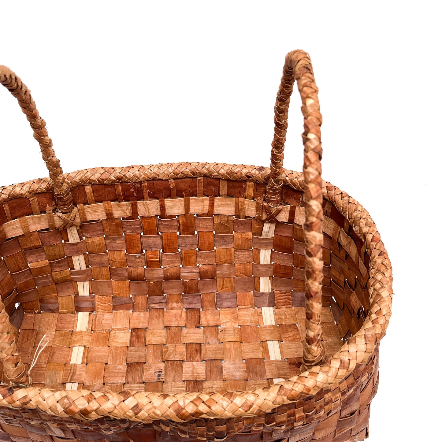 A top-down, angled view of a rectangular woven basket with handles, showing the checkered pattern.