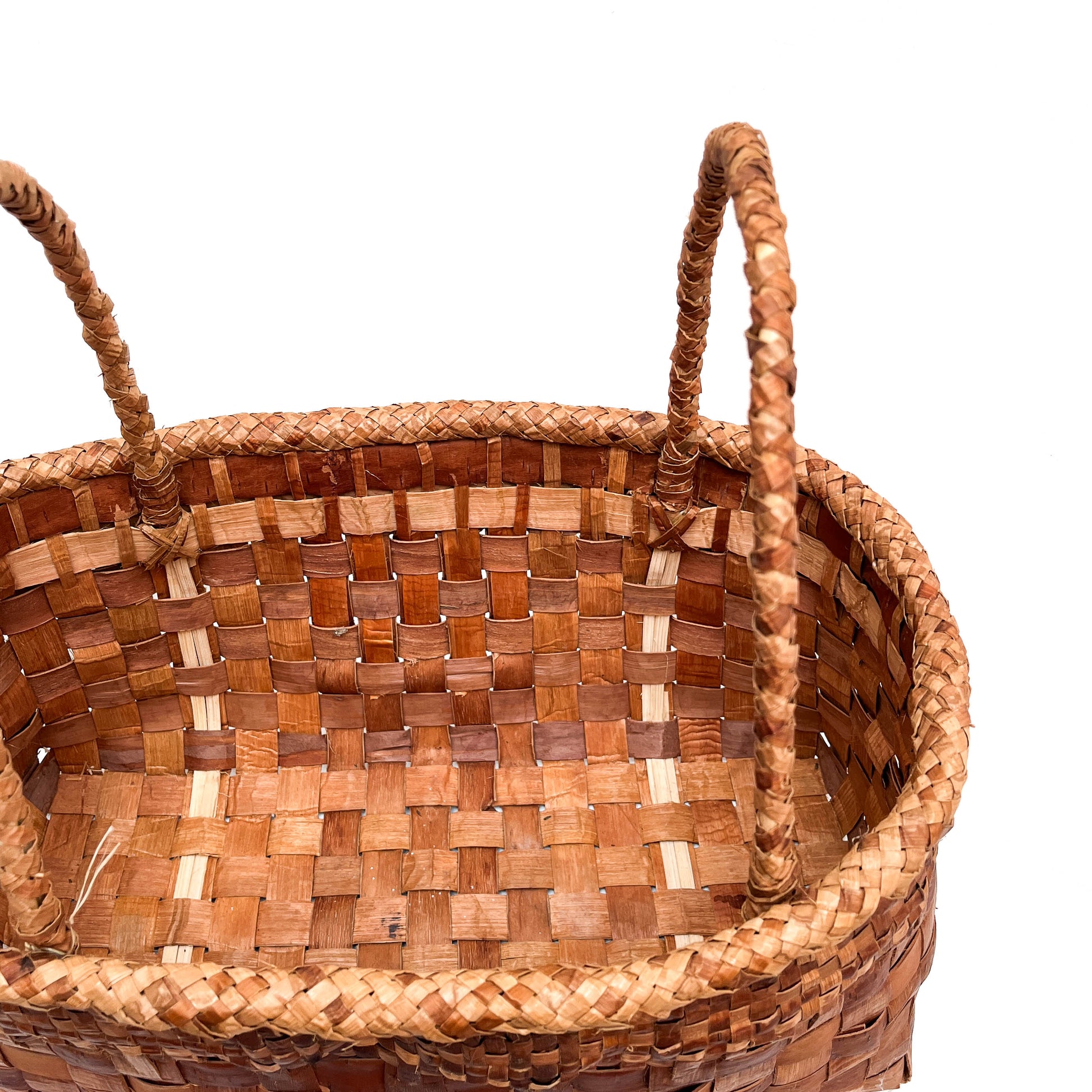 A top-down, angled view of a rectangular woven basket with handles, showing the checkered pattern.