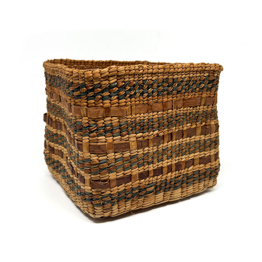 A square woven basket with horizontal stripes of brown and dark blue patterns.