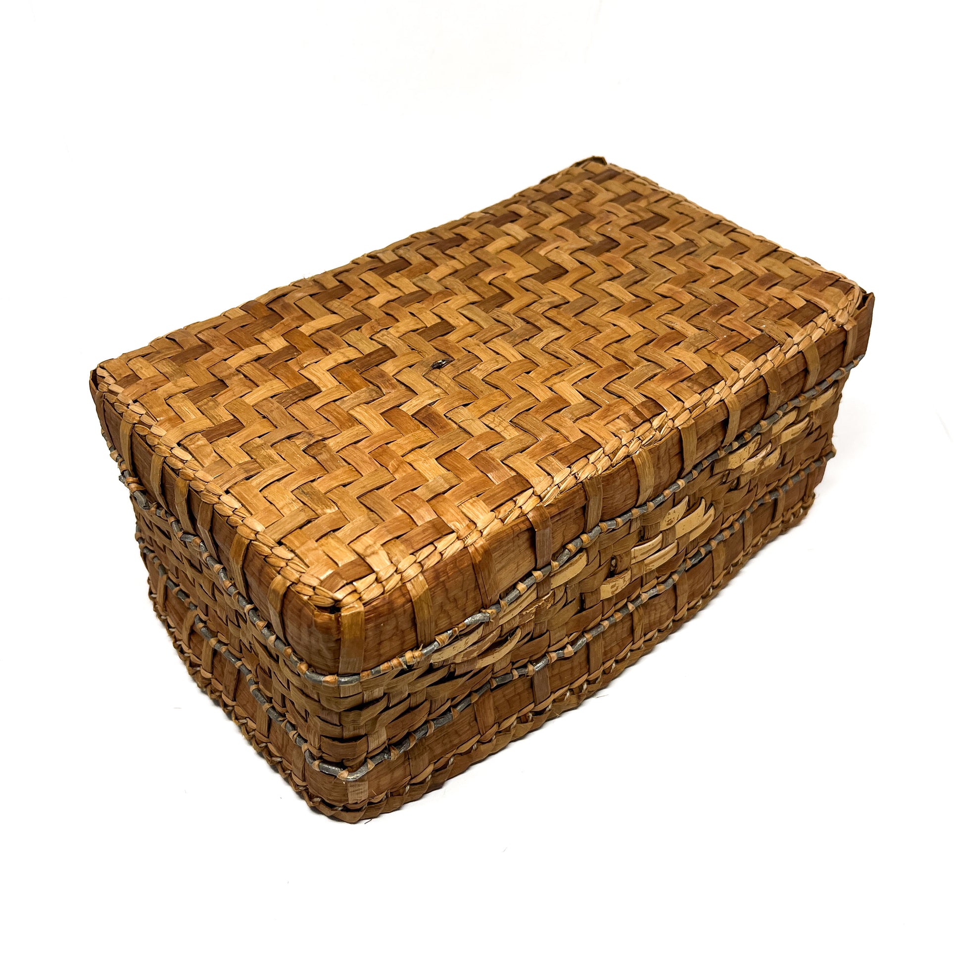 A rectangular woven basket with a brown and tan checkered pattern and a gray accent line, viewed from a low angle.