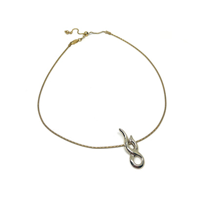 A gold-toned necklace with an adjustable chain and a modern, polished silver pendant featuring a small clear gem.