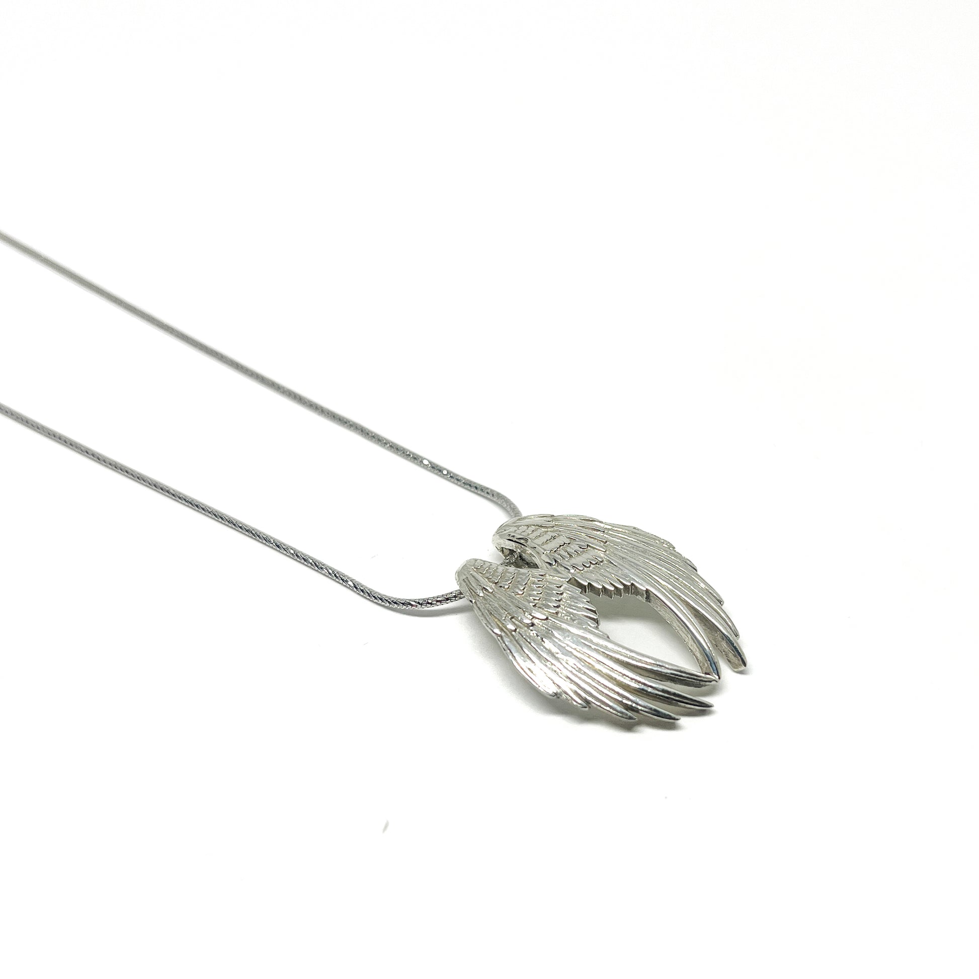 Silver necklace featuring a detailed Angel Wings Pendant with layered feathers on a delicate chain.