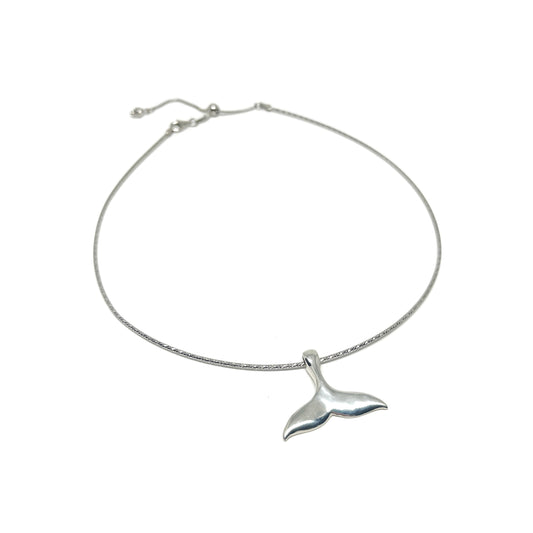A silver anklet featuring a polished whale tail pendant on a delicate, adjustable chain.