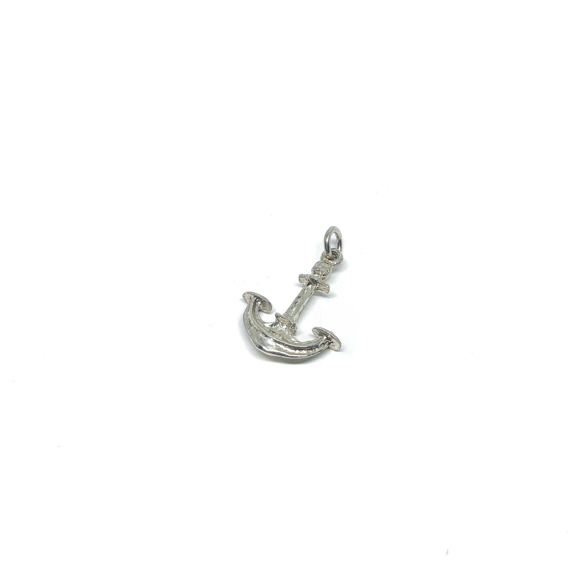 Shiny sterling silver anchor charm with textured details and a small attachment ring.