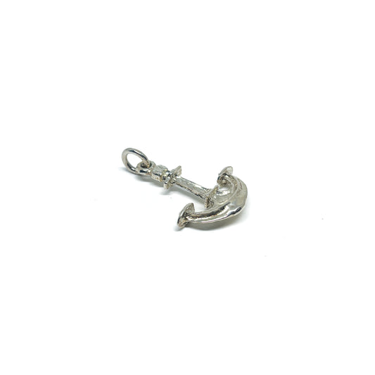 A shiny, textured sterling silver anchor pendant with a small jump ring for attachment.