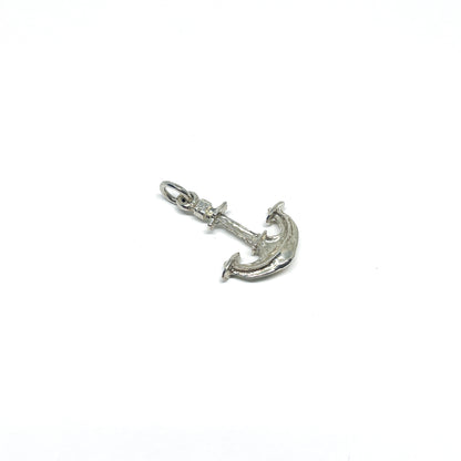 A detailed, shiny sterling silver anchor pendant with a small ring at the top for attaching to jewelry.
