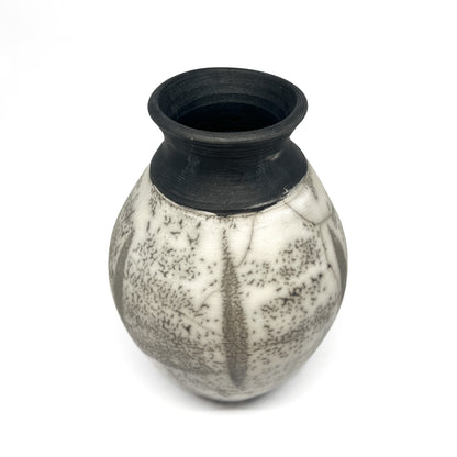 Ceramic vase with a rounded body, short neck, black rim, and crackled black and white glaze.