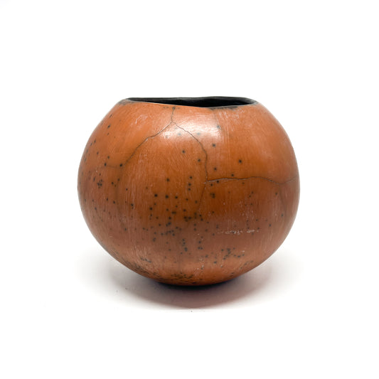 Round ceramic vase with a mottled, earthy-toned glaze, subtle crack lines, and a dark interior.