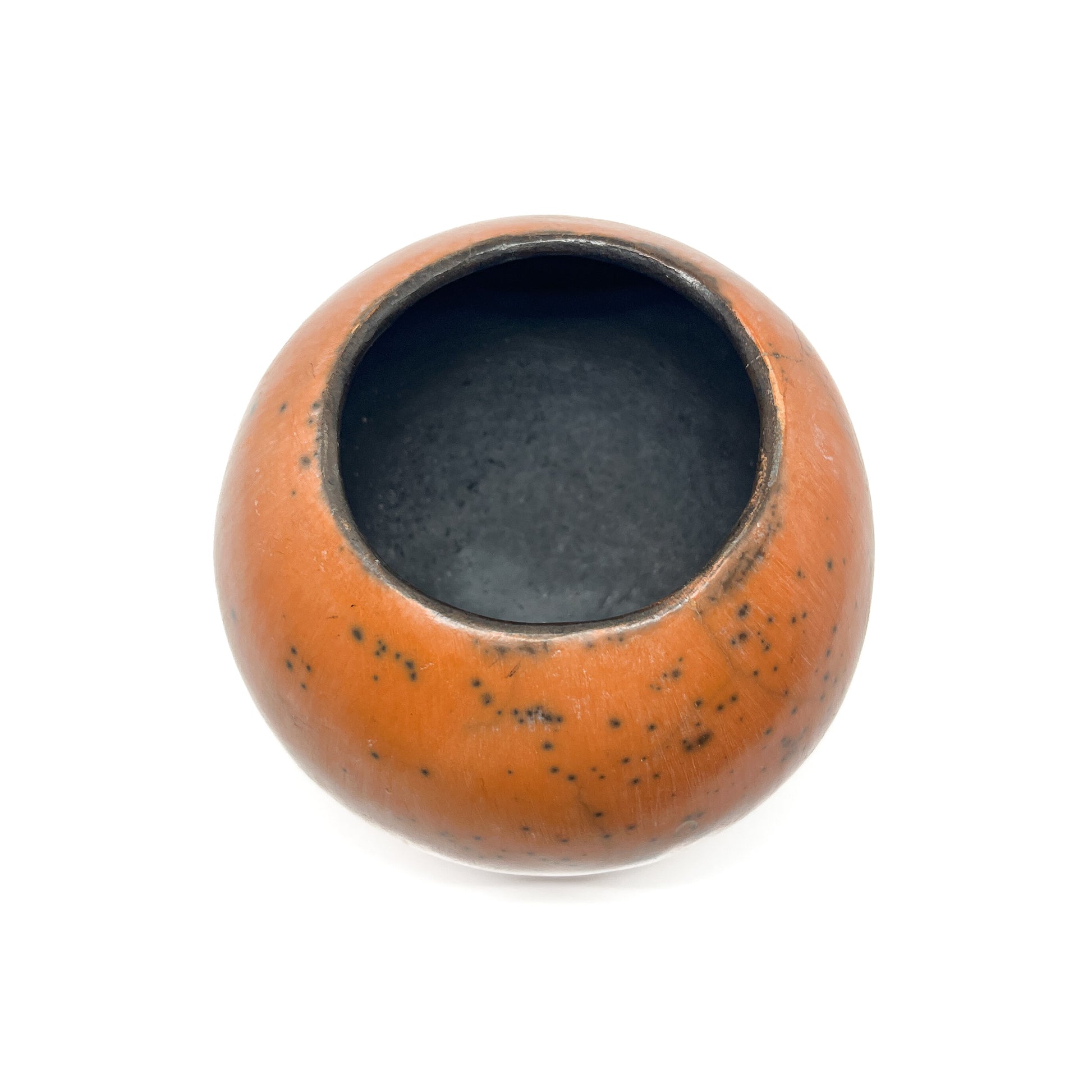 Top-down view of a round ceramic vase with a mottled, earthy-toned glaze and a dark interior.