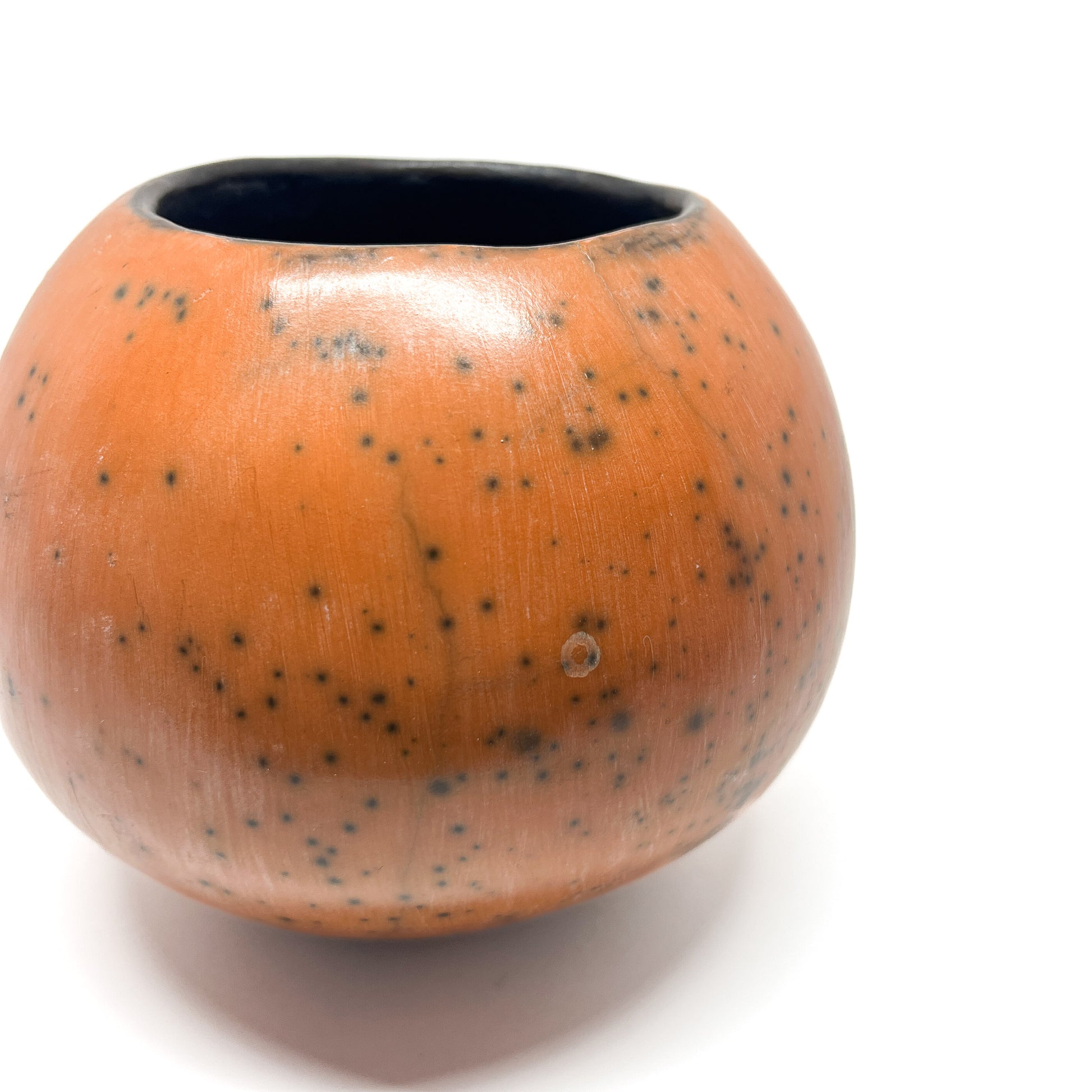 Round ceramic vase with a mottled, earthy-toned glaze and a dark, slightly textured interior.