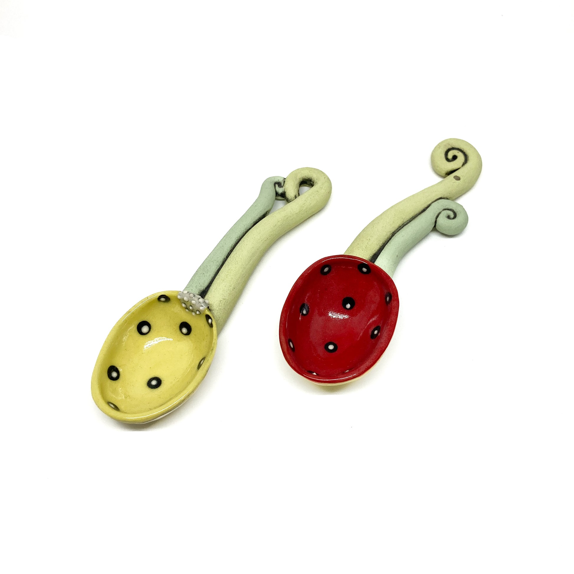 Back of a funky spoon with etched swirl design on the bowl and sculpted dual-tone handle.