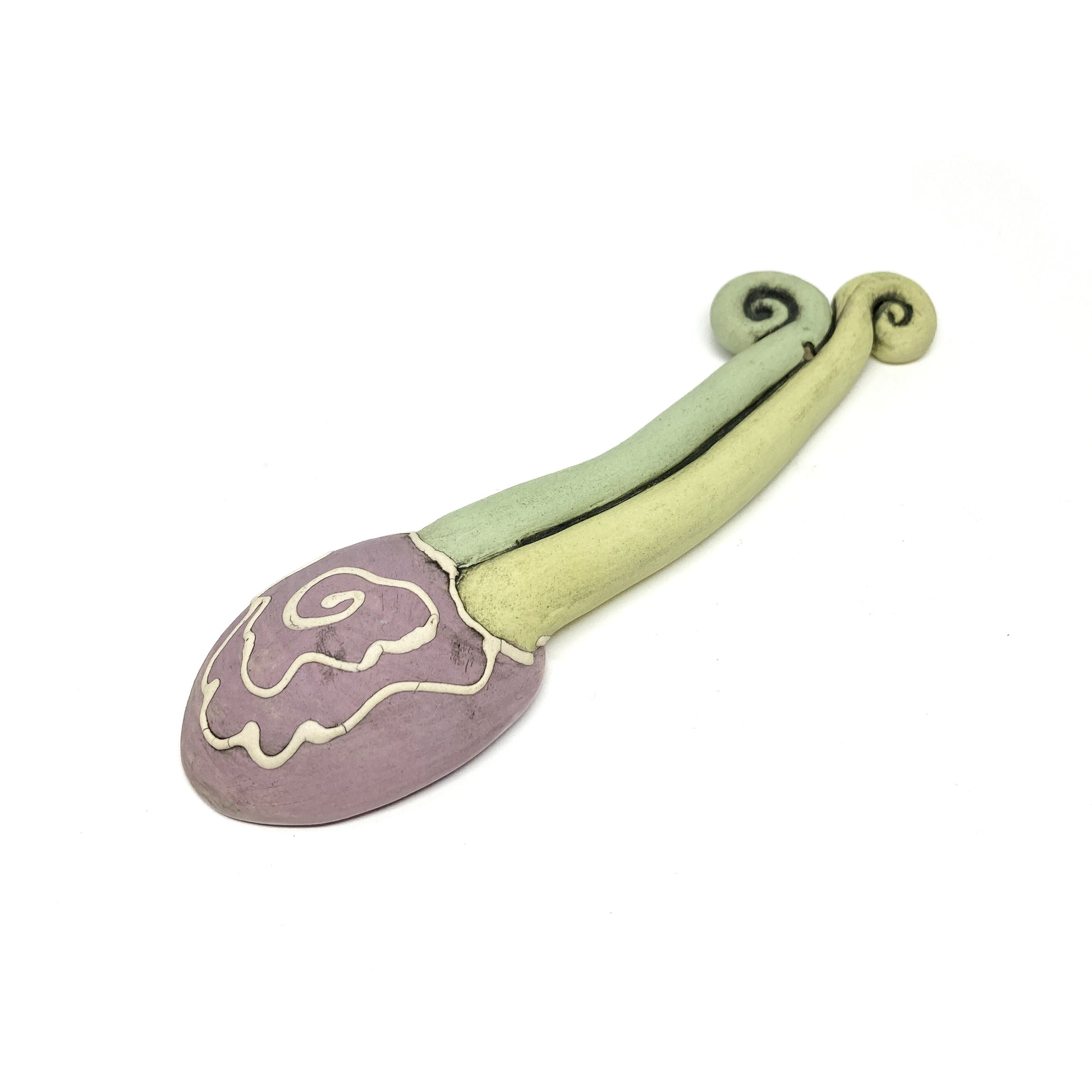 Rear view of a funky spoon with etched swirl detailing on the bowl and twisted artistic handle.