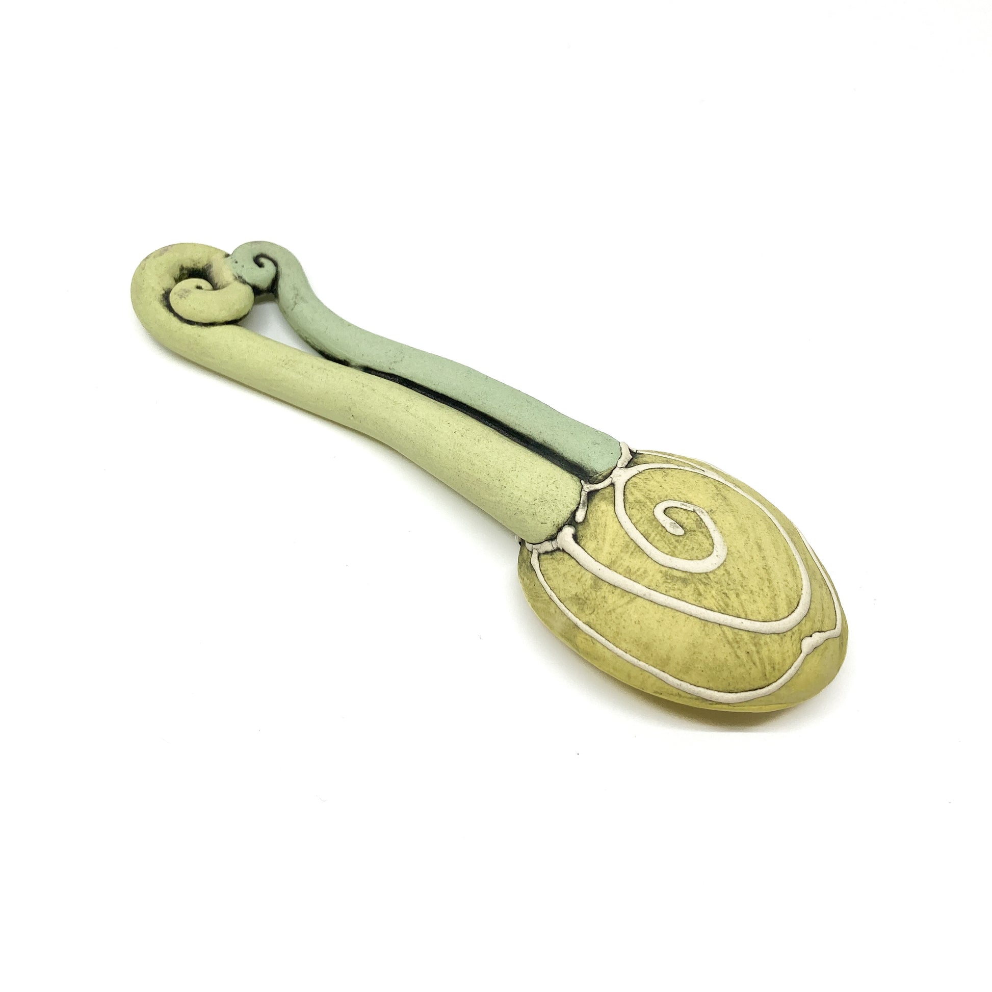 Two funky spoons with colorful, polka-dot bowls and whimsical twisted handles.