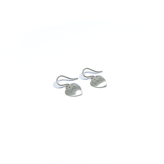 Two silver heart earrings with "YOU CAN" engraved on them, isolated on a white background.