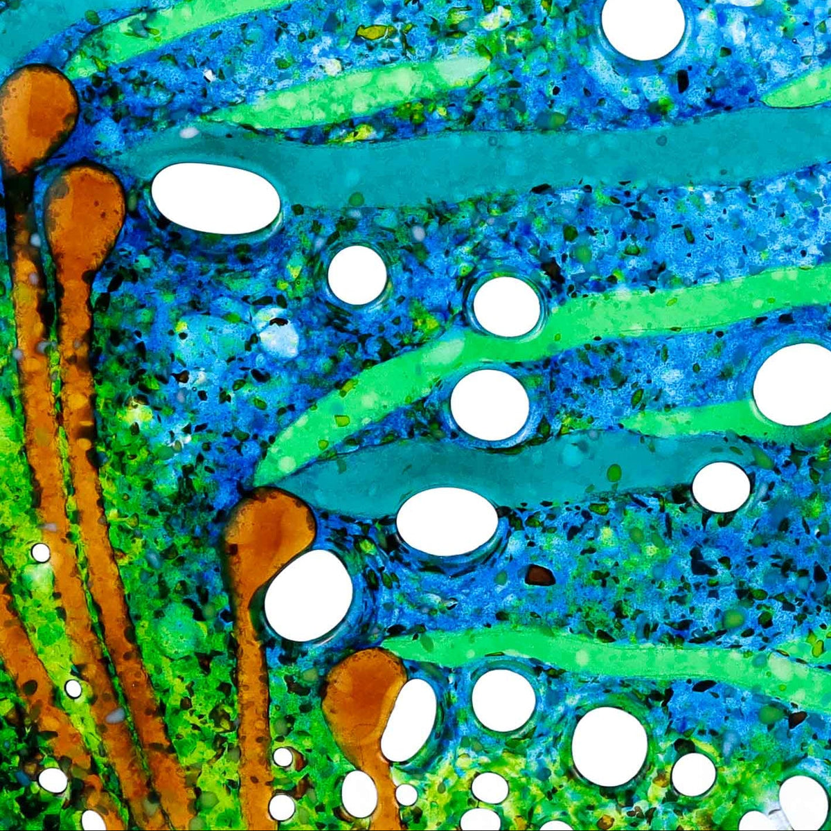 A circular glass art piece featuring a vibrant blue and green abstract design with white bubble-like spots and orange accents, displayed on a black metal stand against a white background.