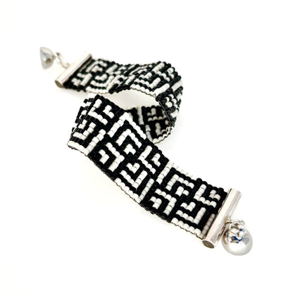 Two beaded bracelets with black and white Greek key patterns feature silver magnetic ball clasps.