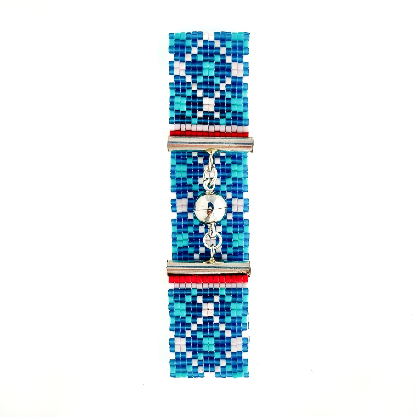 A flat lay shows a beaded bracelet with a blue, light blue, and white geometric pattern and a silver magnetic clasp.