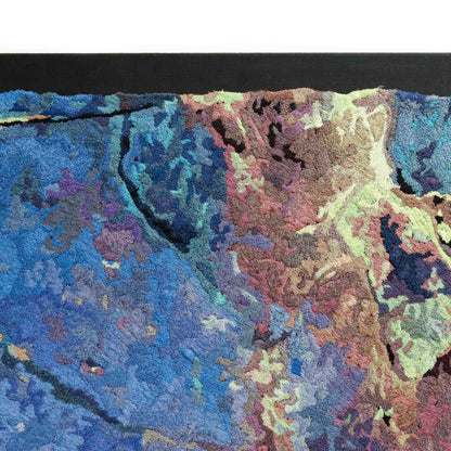 Partial view of a thread painting, showcasing dense stitching and colorful thread in a textured embroidery.