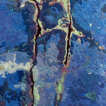 Detailed thread painting close-up, featuring intricate stitching and colorful thread forming an abstract design.