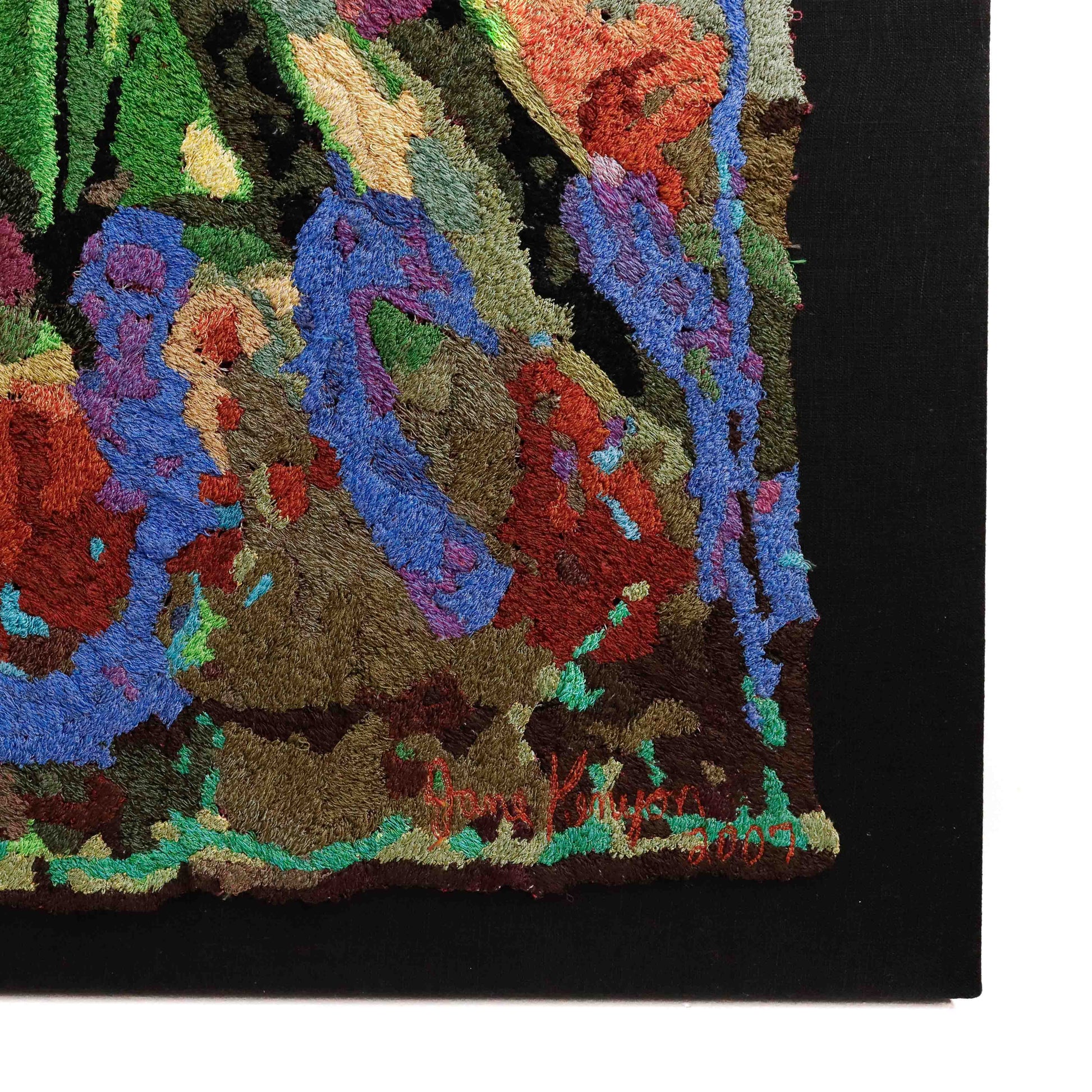 Framed thread tapestry close-up, showcasing dense, colorful thread stitching in an abstract embroidery design. Artist signature visible.