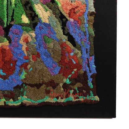 Framed thread tapestry close-up, showcasing dense, colorful thread stitching in an abstract embroidery design. Artist signature visible.