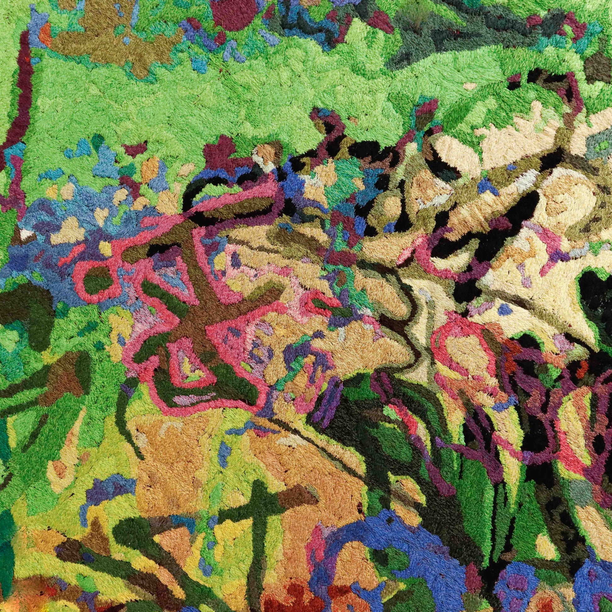 Detailed thread painting close-up, showcasing intricate stitching and a variety of colorful thread in an abstract embroidery.