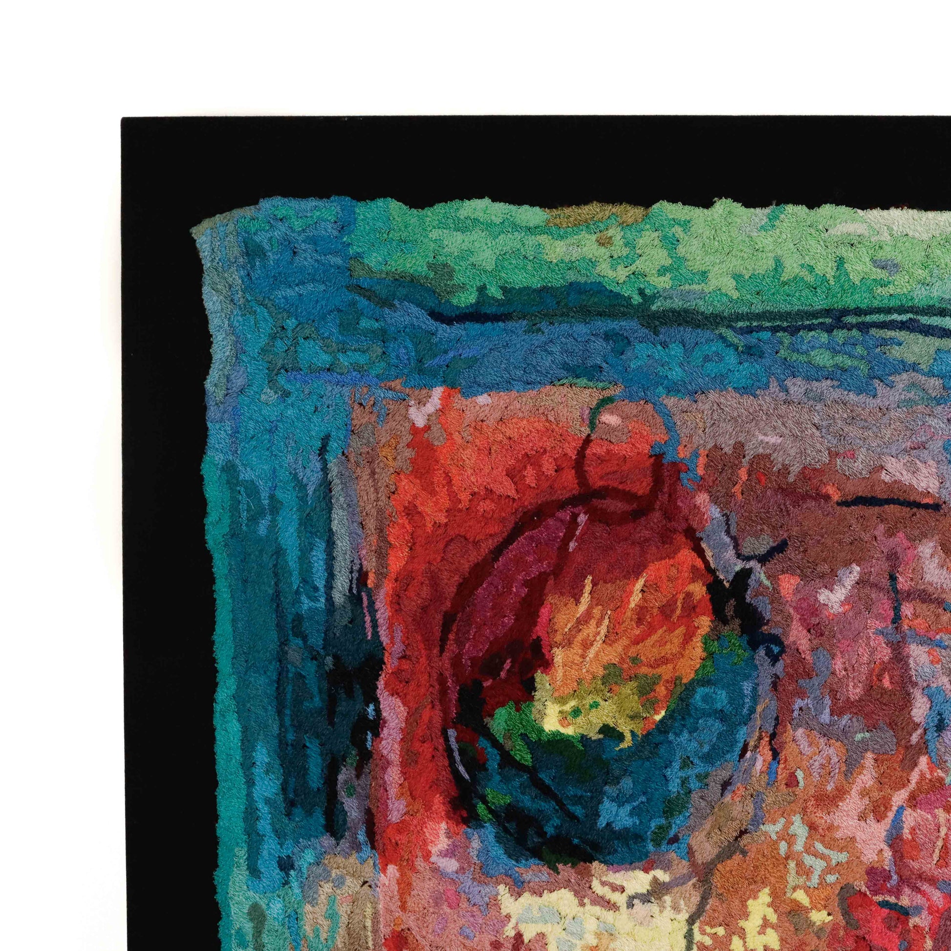 Framed thread painting close-up, showcasing intricate stitching and colorful thread in an abstract embroidery design.