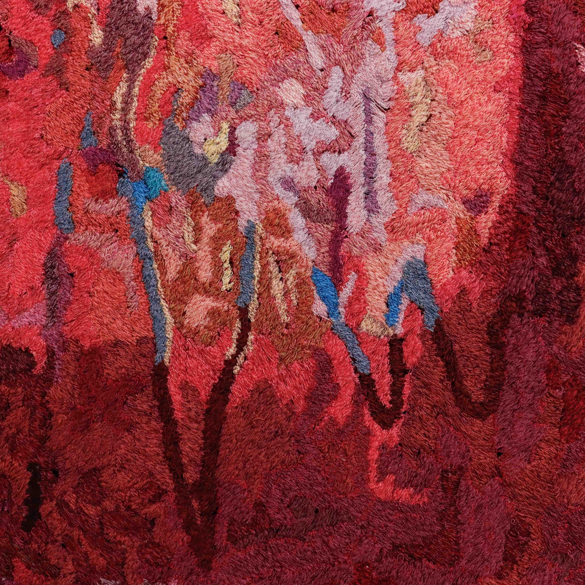 A close-up of a thread painting, showcasing intricate stitching and colorful thread.