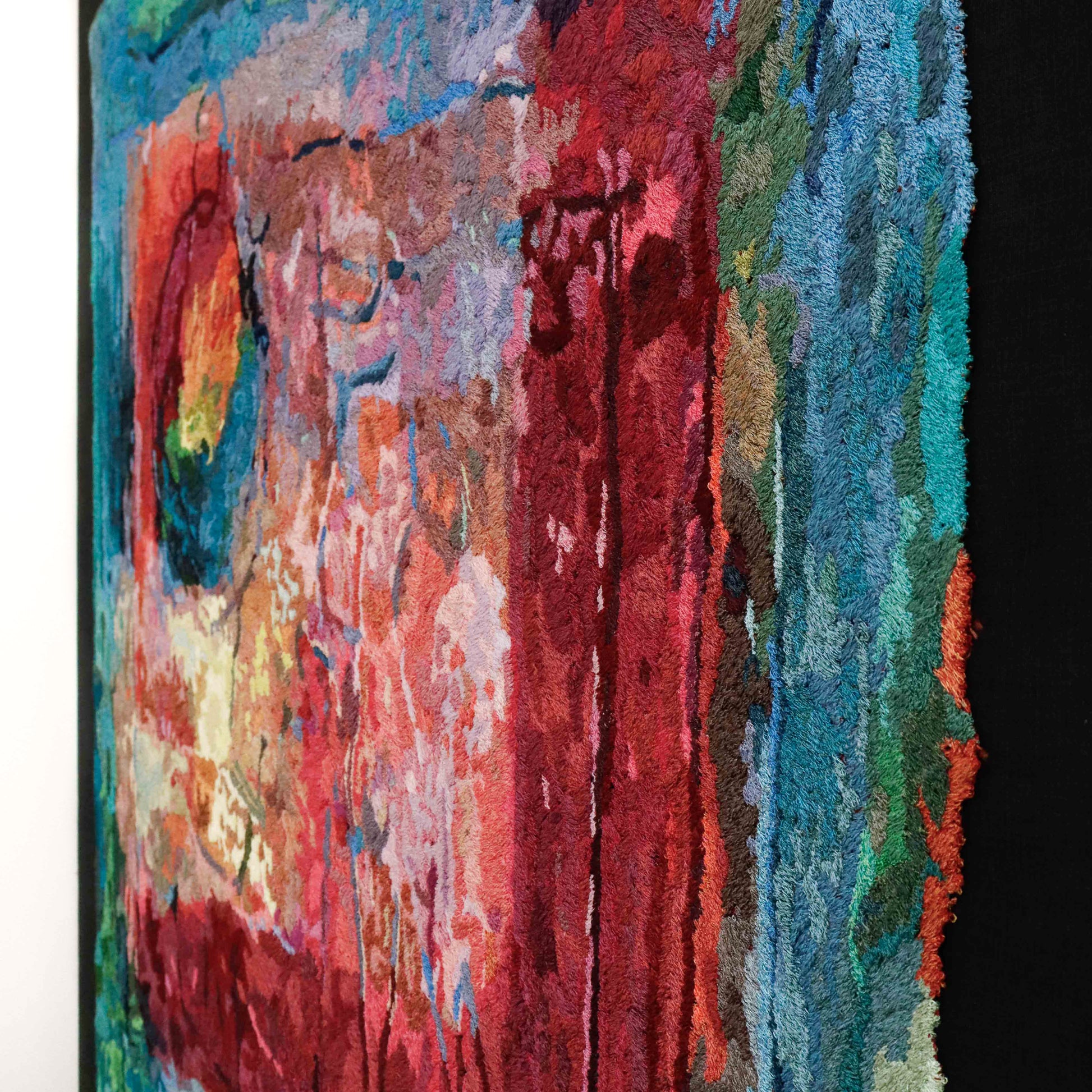 A colorful thread painting with visible stitching, displaying a vibrant.