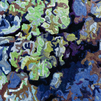 A close-up of a thread painting, highlighting detailed stitching and colorful thread in an abstract thread painting. 