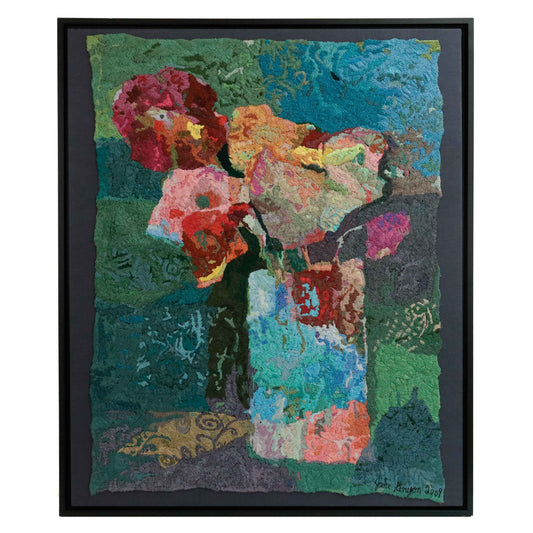 A framed thread tapestry featuring flowers in a vase, showcasing intricate stitching and colorful thread.