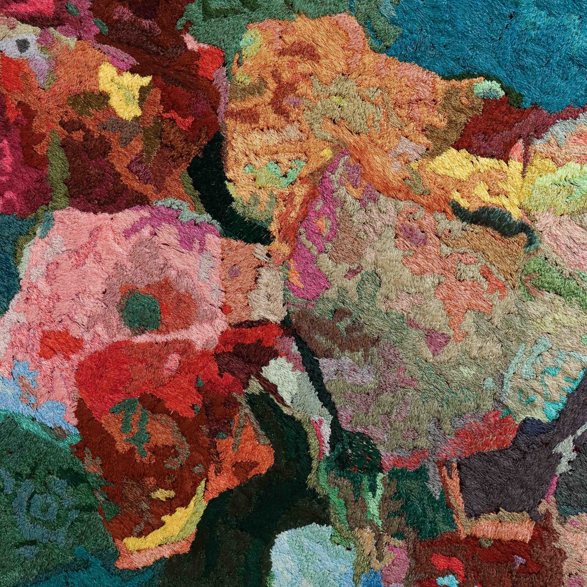 A close-up of a thread tapestry with floral-like patterns, showcasing intricate stitching and colorful thread.