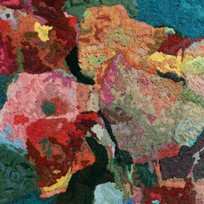 A close-up of a thread tapestry with floral-like patterns, showcasing intricate stitching and colorful thread.